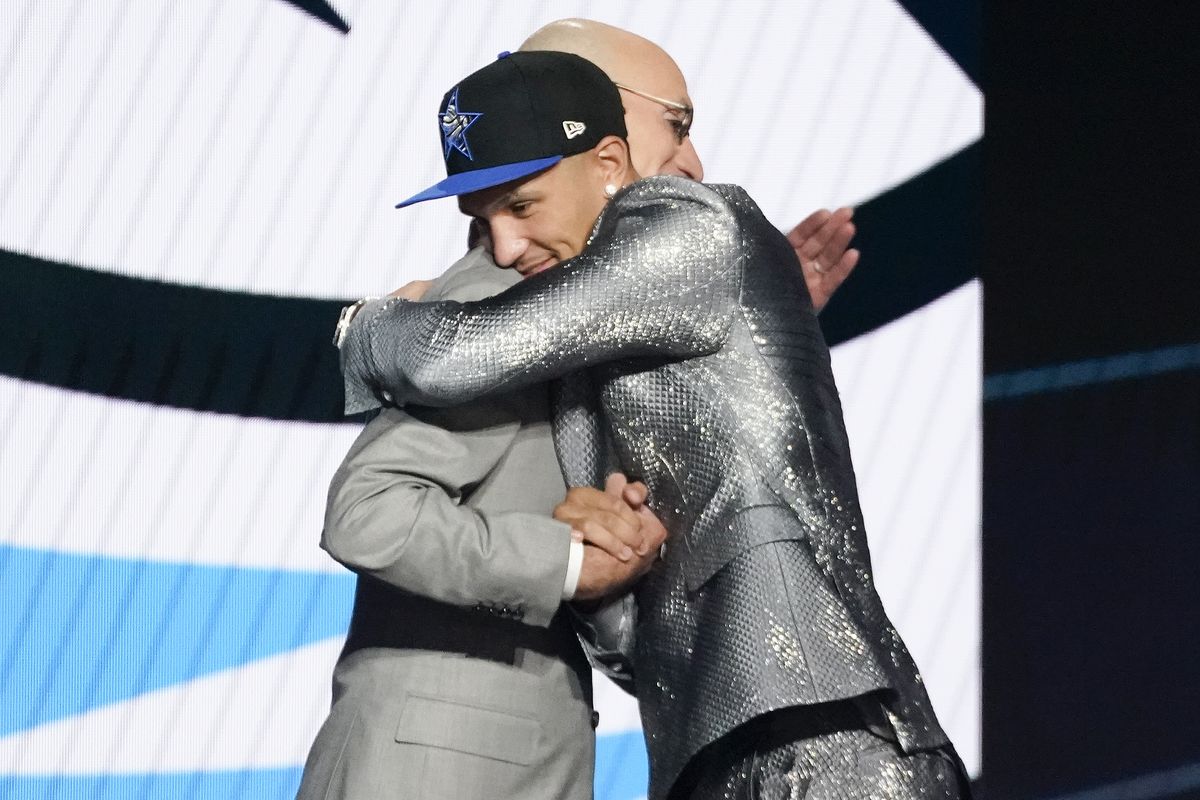 Jalen Suggs hugs NBA Commissioner Adam Silver after being selected fifth overall by the Orlando Magic during the NBA basketball draft Thursday in New York.  (Associated Press)