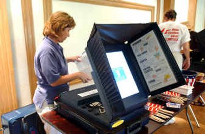 
Roseann Voils reads the manual to the voting machine used in Palm Beach County during the Florida elections during a demonstration Wednesday at a country club in Delray Beach, Fla. A pre-election test had to be postponed Wednesday.
 (Associated Press / The Spokesman-Review)