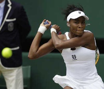 Venus Williams returns to her sister Serena during the women's singles final Saturday on Centre Court at Wimbledon. Associated Press
 (Associated Press / The Spokesman-Review)