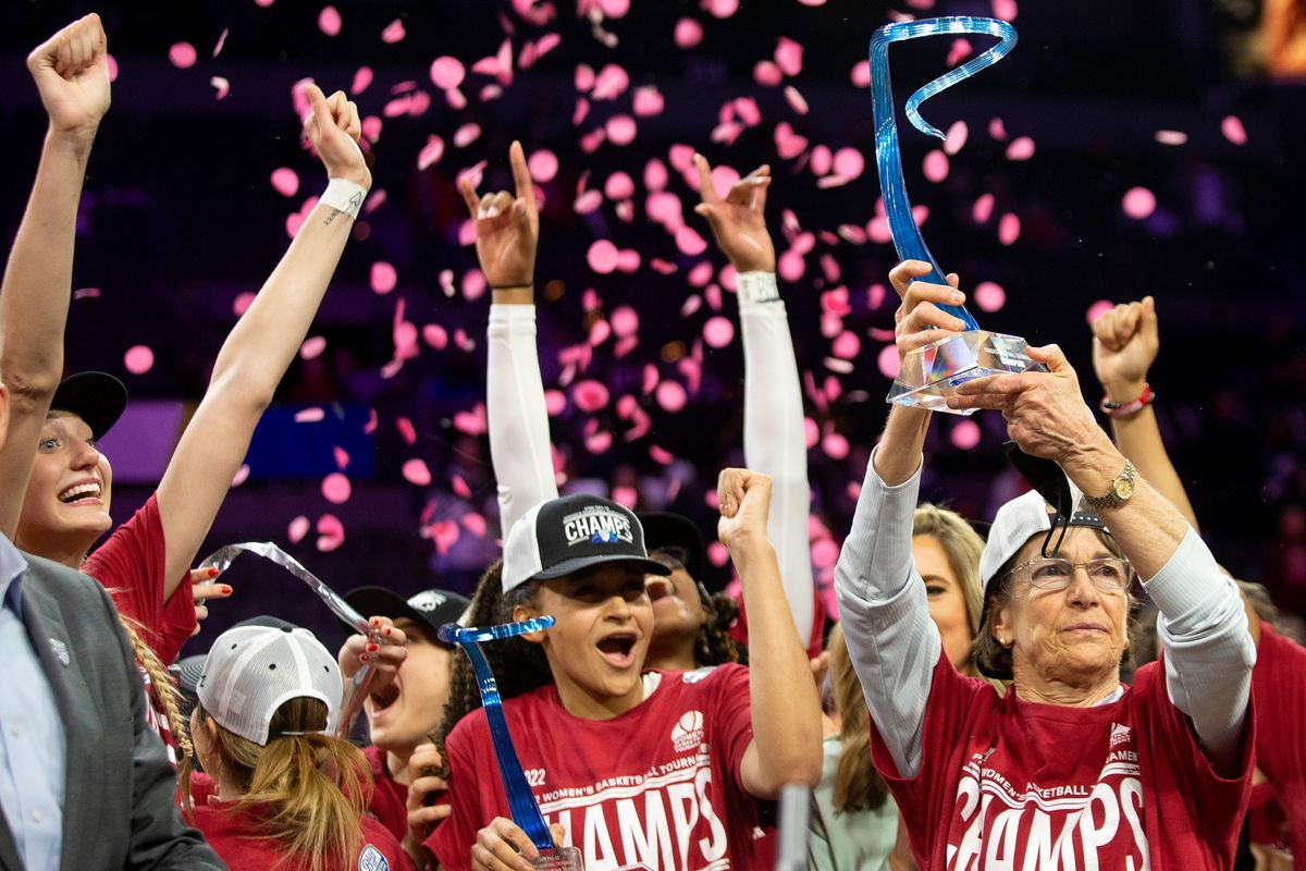 Stanford head coach Tara VanDerveer, right, holds up the winning trophy while her team cheers after they won an NCAA college basketball game for the Pac-12 tournament championship against the Utah Sunday, March 6, 2022, in Las Vegas.  (Ellen Schmidt)