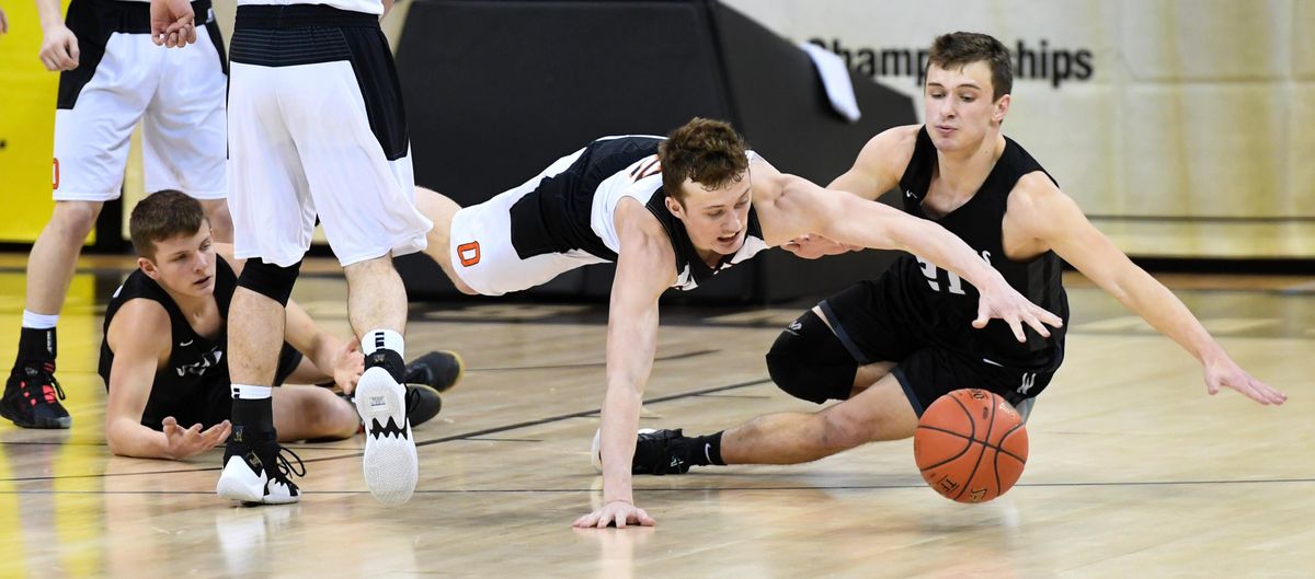 Odessa guard Jett Nelson dives on the floor for a loose ball against Almira Coulee Hartline forward Brayton Schafer, right, Thursday, March 5, 2020 at the 1B Boys Hardwood Classic in the Spokane Arena. (Dan Pelle / The Spokesman-Review)