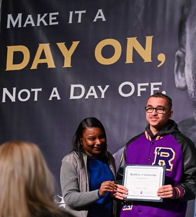 Rogers High School senior Vernon Glass poses with Martin Luther King Jr. Center Executive Director Freda Gandy after accepting the first Happy Watkins scholarship during the MLK march and rally on Jan. 15 at the Spokane Convention Center.  (DAN PELLE/THE SPOKESMAN-REVIEW)