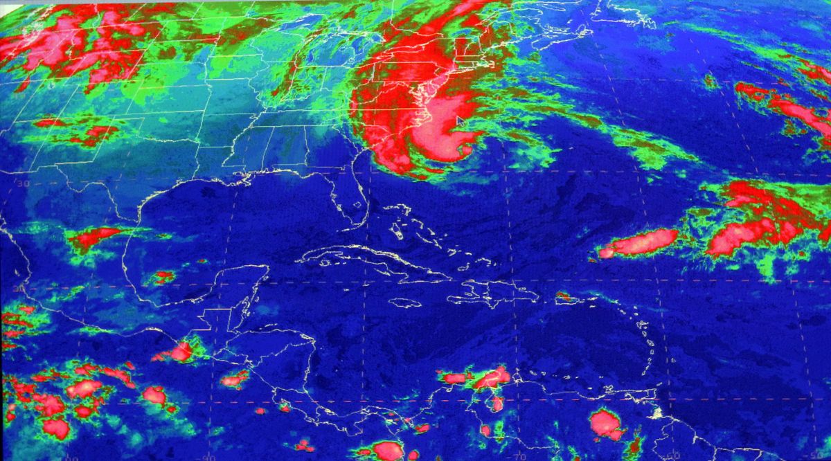 This satellite image from the National Hurricane Center in Miami shows Sandy, at 10:03 a.m., Sunday, Oct. 28, 2012. Hurricane Sandy was headed north from the Caribbean, where it left nearly five dozen dead, to meet a winter storm and a cold front, plus high tides from a full moon, and experts said the rare hybrid storm that results will cause havoc over 800 miles from the East Coast to the Great Lakes. (Uncredited Uncredited / National Hurricane Center)