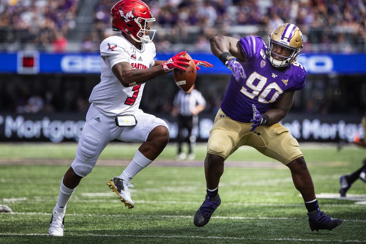 Washington lineman Josiah Bronson flushes Eastern Washington quarterback Eric Barriere out of the pocket Aug. 31, 2019.  (Dean Rutz/The Seattle Times)