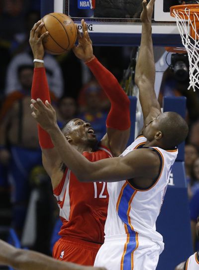 Houston’s Dwight Howard, left, looks to shoot as Oklahoma City’s Serge Ibaka defends. Howard finished with 12 points. (Associated Press)