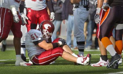 
Will Derting grabs his knee after suffering an injury late in this season's Oregon State game that wiped out his senior season. Next he will take his shot at an NFL career.
 (Christopher Anderson/ / The Spokesman-Review)