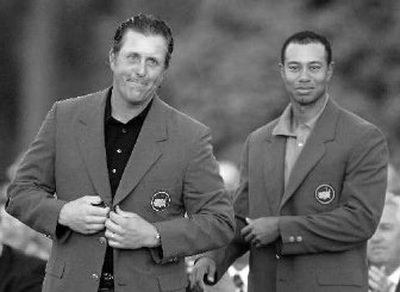 Phil Mickelson, left, and Tiger Woods have been stingy with Masters green jackets the last six years.
(Associated Press / The Spokesman-Review)