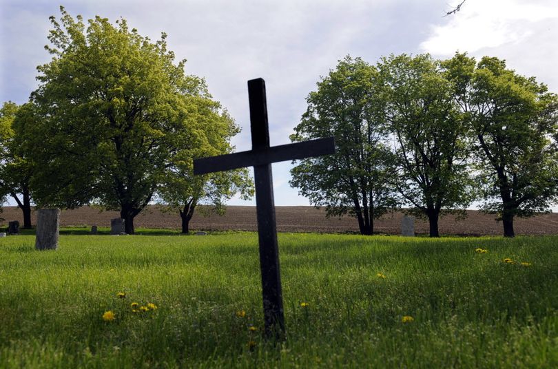 A simple metal cross marks Rudolph Norman's grave. He was buried at the five acre Fairfield Cemetery in 1920.  (J. Bart Rayniak)
