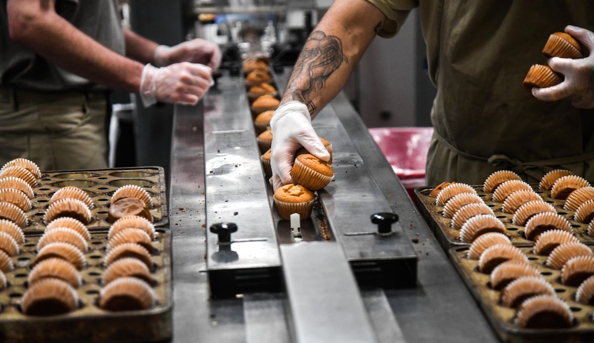 Airway Heights Corrections Center inmates handle orange muffins, Monday, July 9, 2018. (Dan Pelle / The Spokesman-Review)