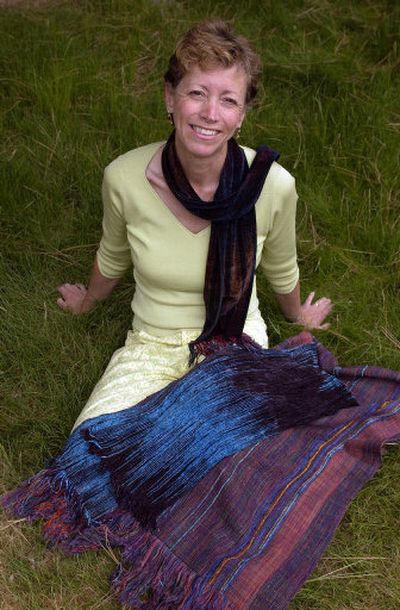 
Loretta West, surrounded by recent creations, learned to use a loom about 10 years ago and since then hasn't stopped making scarves, shawls, wall hangings and blankets.
 (The Spokesman-Review)