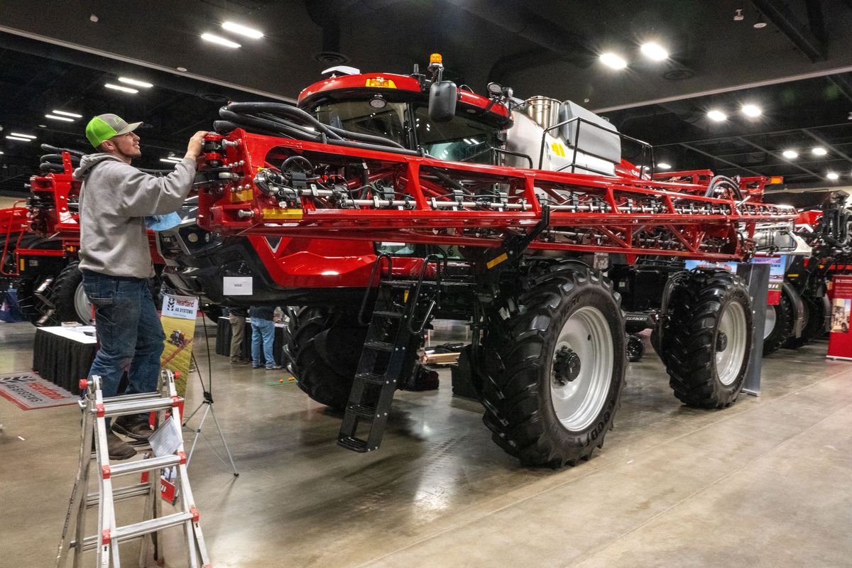 Getting ready for this week’s Spokane Ag Expo and Pacific Northwest Farm Forum, Cole Vienhage shines up a Case Patriot 4450 Sprayer at the Heartland Ag Systems display at the Spokane Convention Center on Monday, Feb. 5, 2024. The 47th-annual Ag Expo runs Tuesday through Thursday this week and is the largest Agriculture Exposition in the Northwest.  (COLIN MULVANY/THE SPOKESMAN-REVIEW)