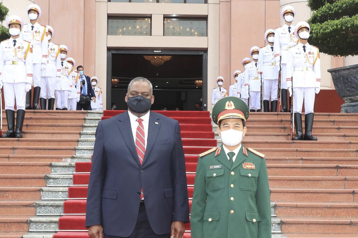 U.S Defense Secretary Lloyd Austin and Vietnamese Defense Minister Phan Van Giang stand for a photo in Hanoi, Vietnam, Thursday, July 29, 2021. Austin is seeking to bolster ties with Vietnam, one of the Southeast Asian nations embroiled in a territorial rift with China, during a two-day visit.  (Nguyen Trong Duc)