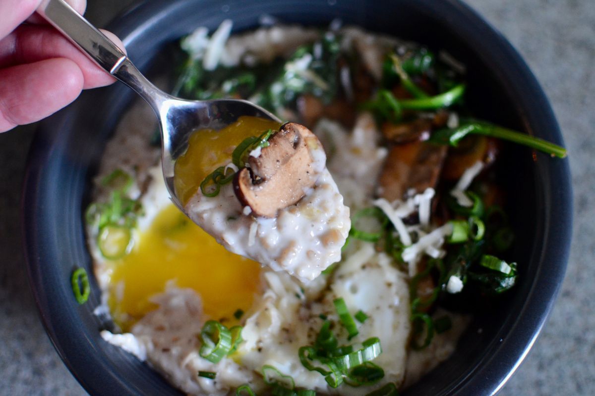 Ricky Webster adds a fried egg, mushrooms, green onions, baby spinach and more to make the breakfast classic oatmeal savory.  (Ricky Webster/For The Spokesman-Review)