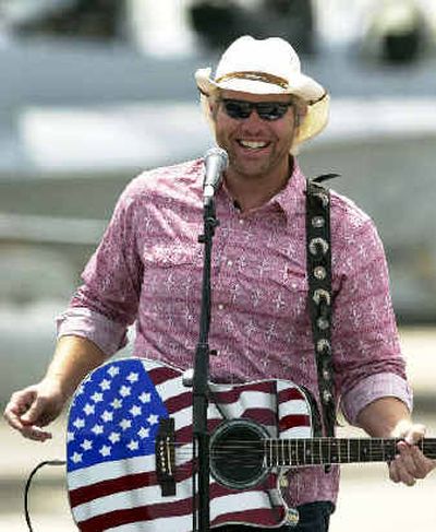 
Country music star Toby Keith entertains a crowd of Marines while they wait for the arrival of President Bush at Marine Corps Air Station Miramar last year.
 (File/Associated Press / The Spokesman-Review)