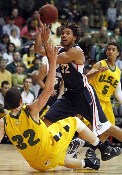 Gonzaga's Steven Gray, with ball, fouls San Francisco's Angelo Caloiaro during the first half of an NCAA college basketball game Saturday, Jan. 30, 2010, in San Francisco. (Ben Margot / Associated Press)