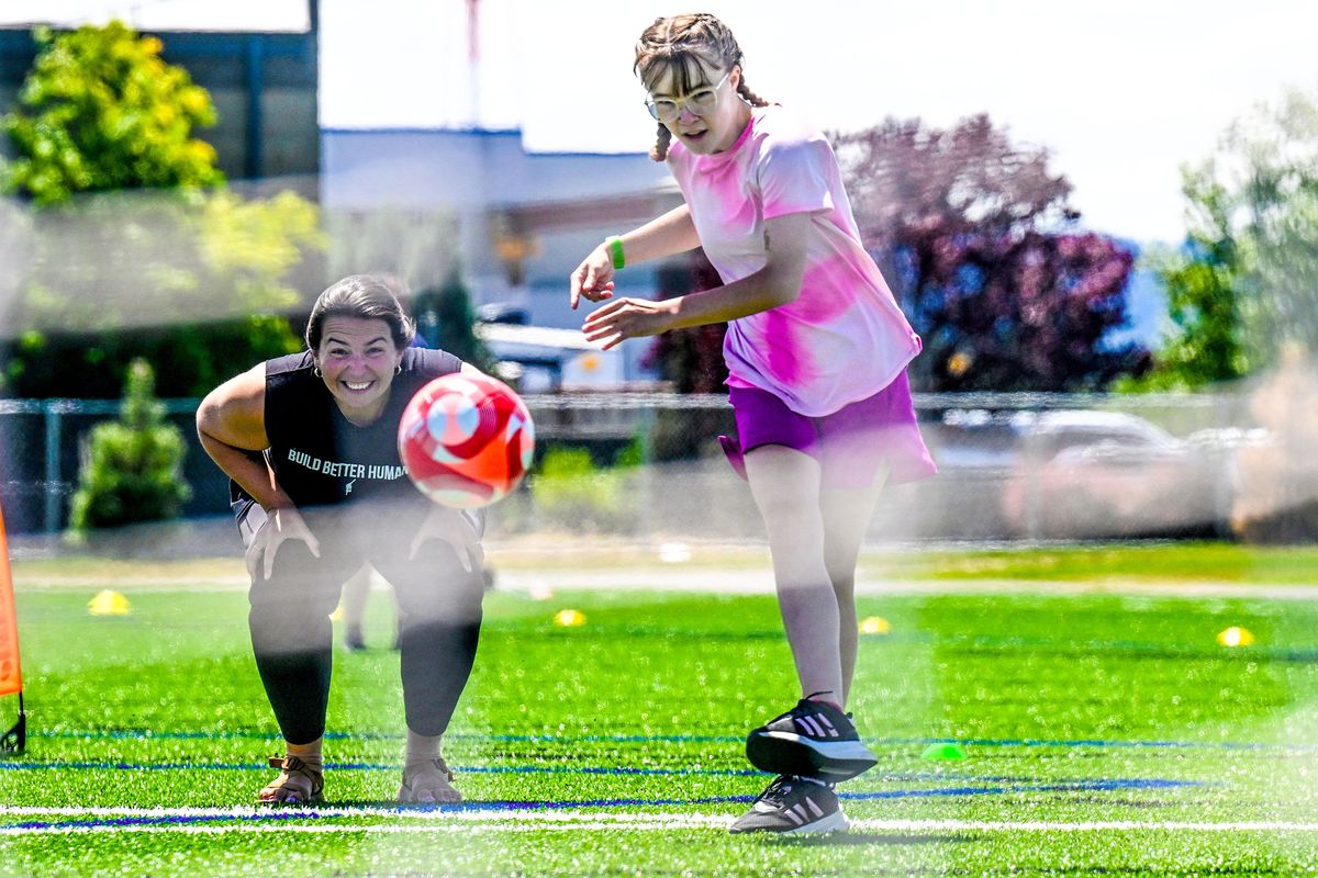Volunteer coach Darby Schmidlkofer cheers on Raquel Kohler, 17, during the first tryouts for the Spokane Impact soccer team last Tuesday at the HUB Sports Center in Liberty Lake. Spokane Impact was created for intellectually and developmentally disabled athletes. (Kathy Plonka/The Spokesman-Review)