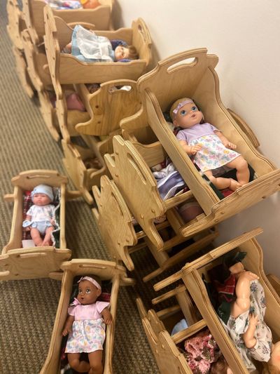 Woodworkers built cradles and filled them with dolls and blankets to give away as toys at this year’s Christmas Bureau.  (Courtesy/Heidi Meany)