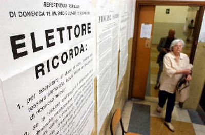 
A voter instruction sign is posted on a wall as voters make their way to cast their ballots in Rome on Monday. Italians were going to the polls for a second day of voting on whether to scrap some of Europe's toughest limits on assisted fertility.
 (Associated Press / The Spokesman-Review)