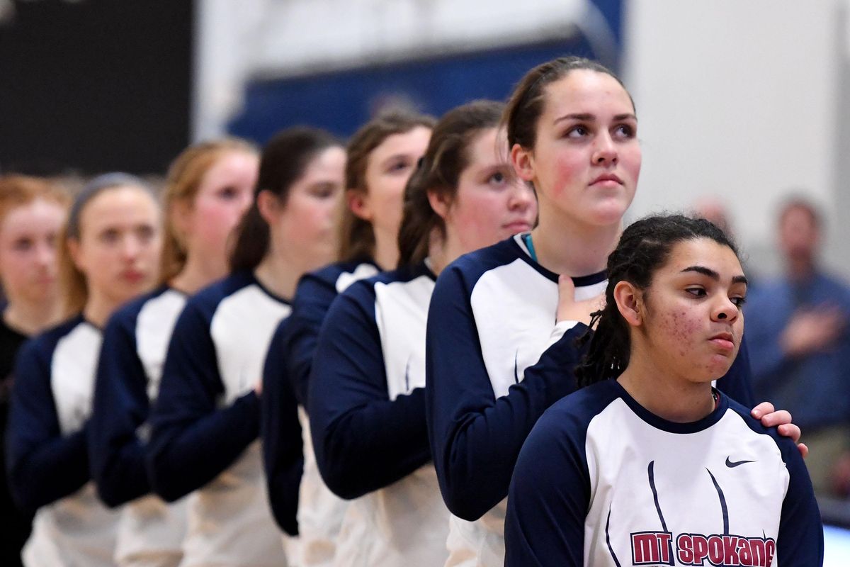 The Mt. Spokane Wildcats stand at attention while the national anthem is played before their GSL basketball game with Gonzaga Prep, Fri., Jan. 6, 2017, at Gonzaga Prep. (Colin Mulvany / The Spokesman-Review)