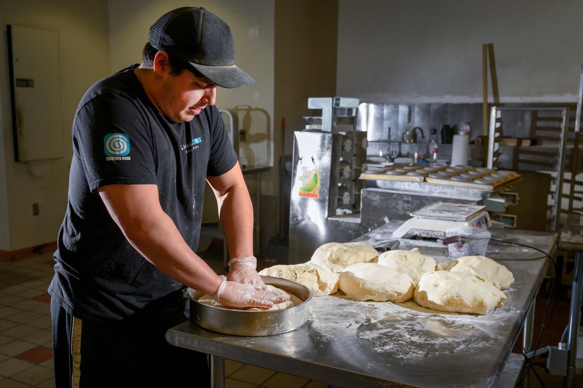 Clay Cerna, who operates Sweetbox Delivery, prepares dough for a batch of bagels he is making in his new commercial kitchen that he’ll also make available to other food businesses in remodeled space in the Spokane Intermodal Center. (Colin Mulvany / The Spokesman-Review)