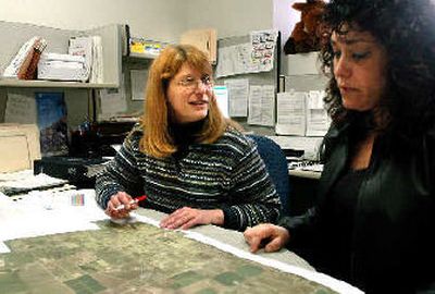 
Hayden Planning Director Lisa Key, left, talks with associate planner Jill Bowes in her City Hall office on Friday. 
 (Jesse Tinsley / The Spokesman-Review)