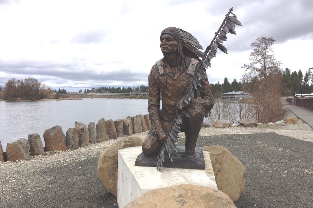 The statue of Chief Morris Buffalo sits poised along the Centennial Trail, near North Idaho College, looking out at the confluence of Lake Coeur d