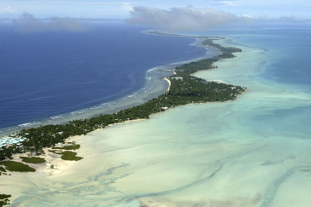 In this March 30, 2004, photo, Tarawa atoll, Kiribati, is seen in an aerial view. Kiribati and several other small Pacific nations were among the last on the planet to have avoided any virus outbreaks, thanks to their remote locations and strict border controls. But their defenses appear no match against the highly contagious omicron variant.  (Richard Vogel)