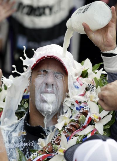 Tony Kanaan, of Brazil, celebrates with winner’s milk after his Indianapolis 500 victory on Sunday. (Associated Press)