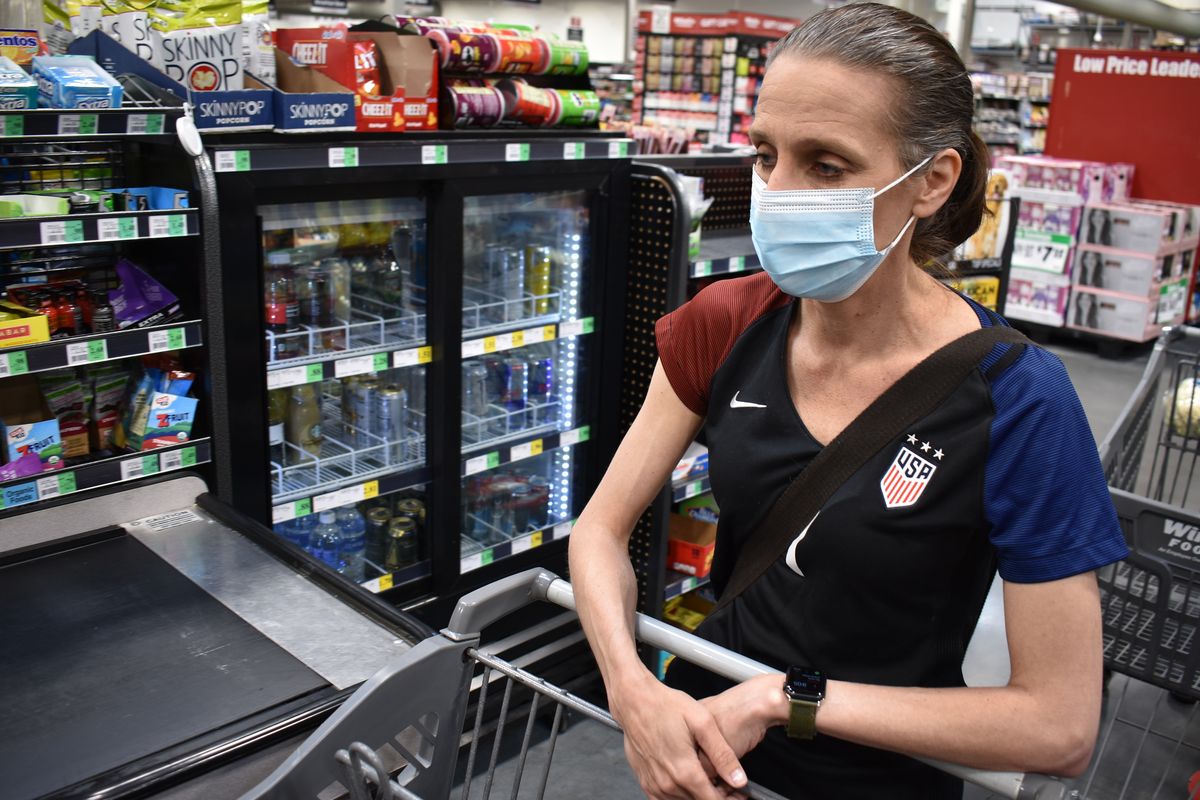 Crystal Dvorak shops at WinCo Foods, Saturday, May, 7, 2021, in Billings, Mont. Dvorak recently lost her job as an audiologist. The day Montana Gov. Greg Gianforte announced the $300 benefit would end June 27 was Dvorak’s second day of unemployment.  (Matthew Brown)