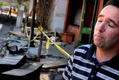 John Mark, operation manager for Dorian Studios photography and son of the business’ owners, met with investigators Monday at the burned Joel building. “I’m still fighting back the tears,” Mark said, recalling personal items lost in the blaze that burned through all three of Dorian’s floors.  (Brian Plonka / The Spokesman-Review)