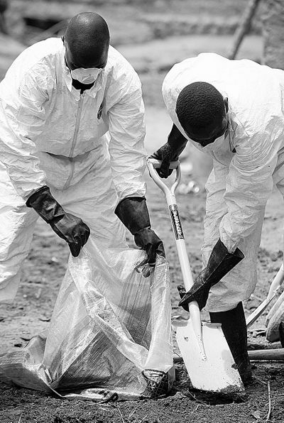 Local health workers remove earth contaminated by lead from a family compound in the village of Dareta in Gusau, Nigeria, on Thursday.  (Associated Press)