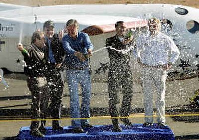 
 SpaceShipOne team members  celebrate after the space plane's successful flight Monday. 
 (Associated Press / The Spokesman-Review)