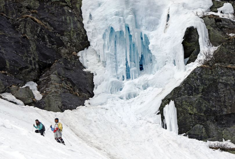 In this Sunday, May 3, 2015 photo, ice clings to a cliff at Tuckerman Ravine on Mount Washington in New Hampshire. Avalanches, falling ice, crevasses and undermined snow are some of the dangers faced by backcountry skiers at the birthplace of extreme skiing. (Robert Bukaty / Associated Press)