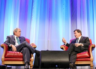 Former President George W. Bush speaks with former Canadian Ambassador to the United States Frank McKenna on Tuesday.  (Associated Press / The Spokesman-Review)