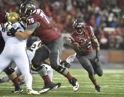 Washington State Cougars offensive lineman Cody O'Connell blocks for running back Gerard Wicks against UCLA on Oct. 15 in Martin Stadium. O’Connell was named to the AP All-American first team on Monday. (Tyler Tjomsland / The Spokesman-Review)
