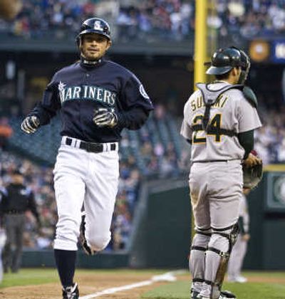 
Ichiro Suzuki scores in the first inning, but the Mariners couldn't dig out of an early hole against the A's on Friday. Associated Press
 (Associated Press / The Spokesman-Review)