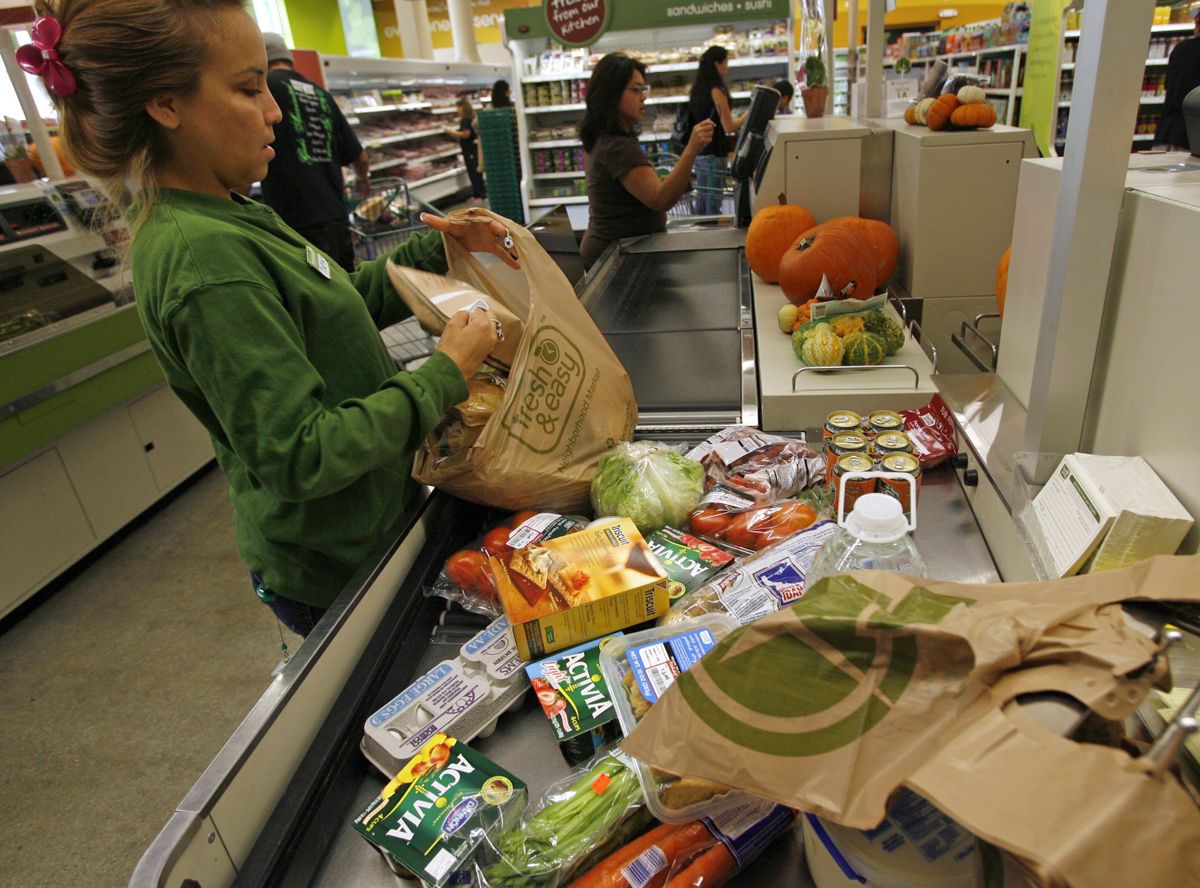 Customer assistant Karla Flores bags groceries at the Fresh & Easy Neighborhood Market in the Eagle Rock section of Los Angeles. The 10,000-square-foot market is part of a growing trend of small-format stores that are popping up all over the country as grocers cope with rising costs and limited capital. Associated Press photos (Associated Press photos / The Spokesman-Review)