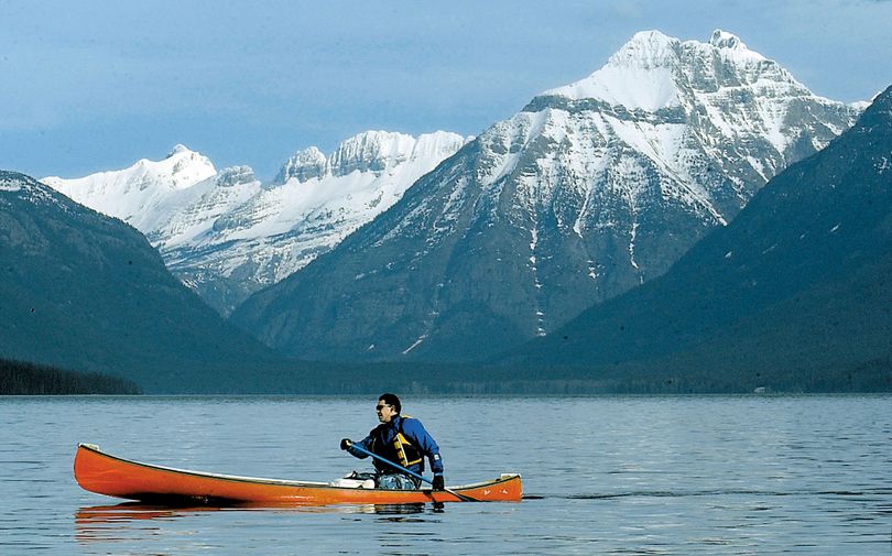FILE - In this Feb. 3, 2005 file photo, Jon Crandall of Coram, Mont., paddles his canoe across Lake McDonald  in Glacier National Park, Mont. Scientists said Wednesday, April 7, 2010 that Glacier National Park has lost two more of its namesake moving icefields to climate change, which is shrinking the rivers of ice until they grind to a halt (Karen Nichols / Daily Inter Lake)