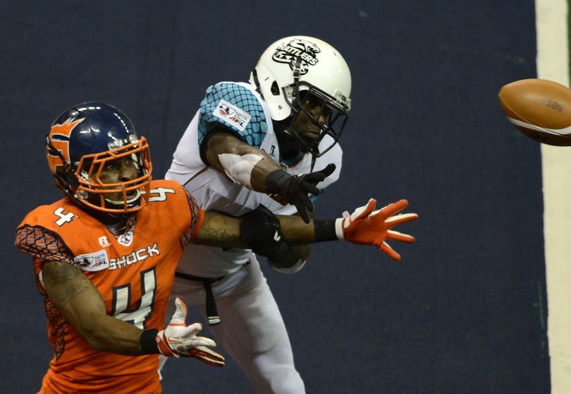 Spokane Shock's wide receiver Duane Brooks (4) eyes the ball as Arizona Rattlers defender Virgil Gray breaks up the reception in the third quarter of their AFL game, Friday, April 12, 2013, in the Spokane Arena. (Colin Mulvany / The Spokesman-Review)