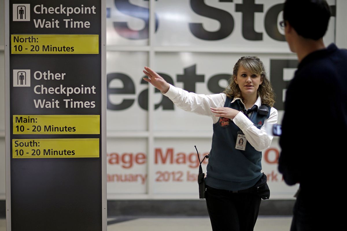 Customer service representative Julia Jacoby directs a traveler to the nearest security checkpoint at Hartsfield-Jackson Airport, Wednesday, Nov. 21, 2012, in Atlanta. Feeling the pinch of the sluggish economic recovery, many Americans setting out on the nation