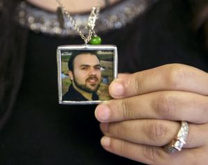 Naghmeh Abedini, holds a necklace with a photograph of her husband, Saeed Abedini, on Capitol Hill in Washington, Tuesday, June 2, during a House Foreign Affairs Committee hearing with four people whose family members are being held in Iran. (AP File Photo/Jacquelyn Martin)