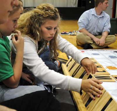 In this April 7, 2010 photo, Eastern Middle School eighth grader Brittany Martin arrange their giant letters while playing a game of Scrabble during a pep rally at Solsberry, Ind. The middle school students will be competing in the National Scrabble Competition at Orlando, Fla. this weekend. (Chris Howell / Bloomington Herald-times)