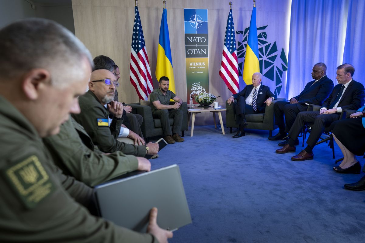 Above: President Joe Biden meets with President Volodymyr Zelenskyy of Ukraine during the NATO Summit in Vilnius, Lithuania, on Wednesday. The Ukrainian leader has secured new weapons pledges, but it was not clear when the aid would arrive, or how consequential it would be on the battlefield. Left: A recruit with Ukraine’s 3rd Brigade during a training exercise in the eastern Donetsk region on Saturday.  (DOUG MILLS)
