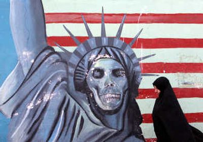 
An Iranian woman walks past a painting of the Statue of Liberty on the wall of the former U.S. Embassy in Tehran, Iran.Associated Press
 (Associated Press / The Spokesman-Review)