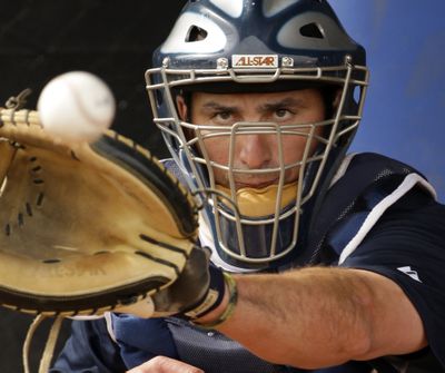 ORG XMIT: AZCR106 Seattle Mariners catcher Jamie Burke catches a ball during baseball spring training Monday, Feb. 16, 2009 in Peoria, Ariz. (AP Photo/Charlie Riedel) (Charlie Riedel / The Spokesman-Review)