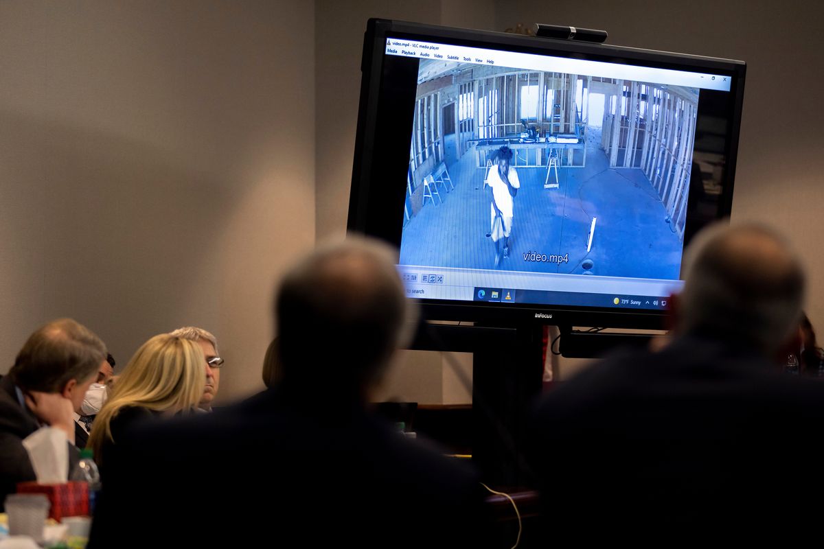 Prosecutor Linda Dunikoski shows a video of Ahmaud Arbery walking through a house under construction during the trial of Greg McMichael and his son, Travis McMichael, and a neighbor, William "Roddie" Bryan in the Glynn County Courthouse, Tuesday, Nov. 9, 2021, in Brunswick, Ga. The three are charged with the February 2020 slaying of 25-year-old Ahmaud Arbery.  (Stephen B. Morton)