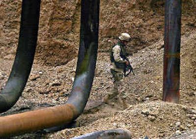 
U.S. Army Capt. Denis Stitt, of 116 Engineers of Coeur d'Alene, inspects oil pipelines near Beiji, about 150 miles north of Baghdad, Iraq, on Sunday. Persistant sabotage of pipelines has impeded oil distribution.
 (Associated Press / The Spokesman-Review)