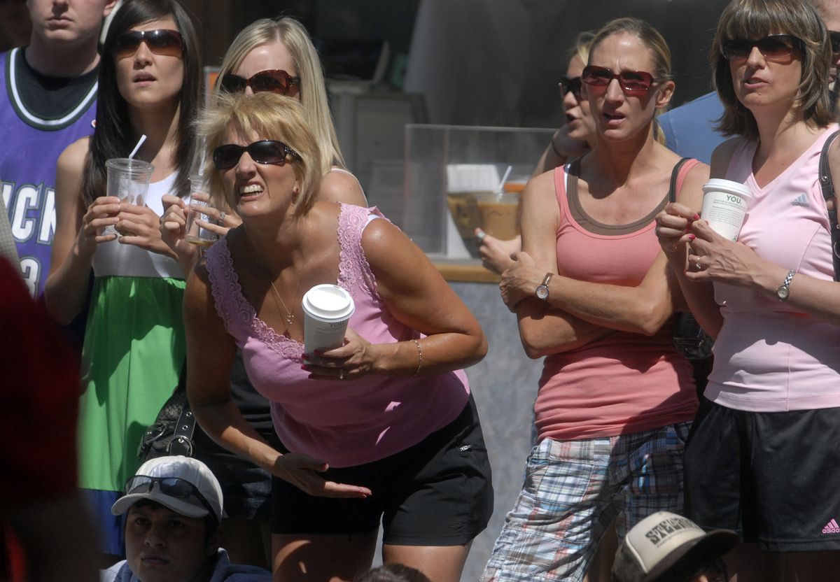 Carol Ann Christnacht, center, said she and her husband, Brad Smith, have learned how to keep their emotions in check while watching their sons compete at Hoopfest. (J. BART RAYNIAK / The Spokesman-Review)