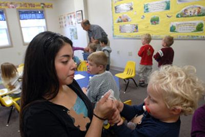 
Sara Ward and Paul Unger prepare children for a snack while the kid's mothers participate in the MOPS program at South Hill Bible School.
 (Dan Pelle / The Spokesman-Review)