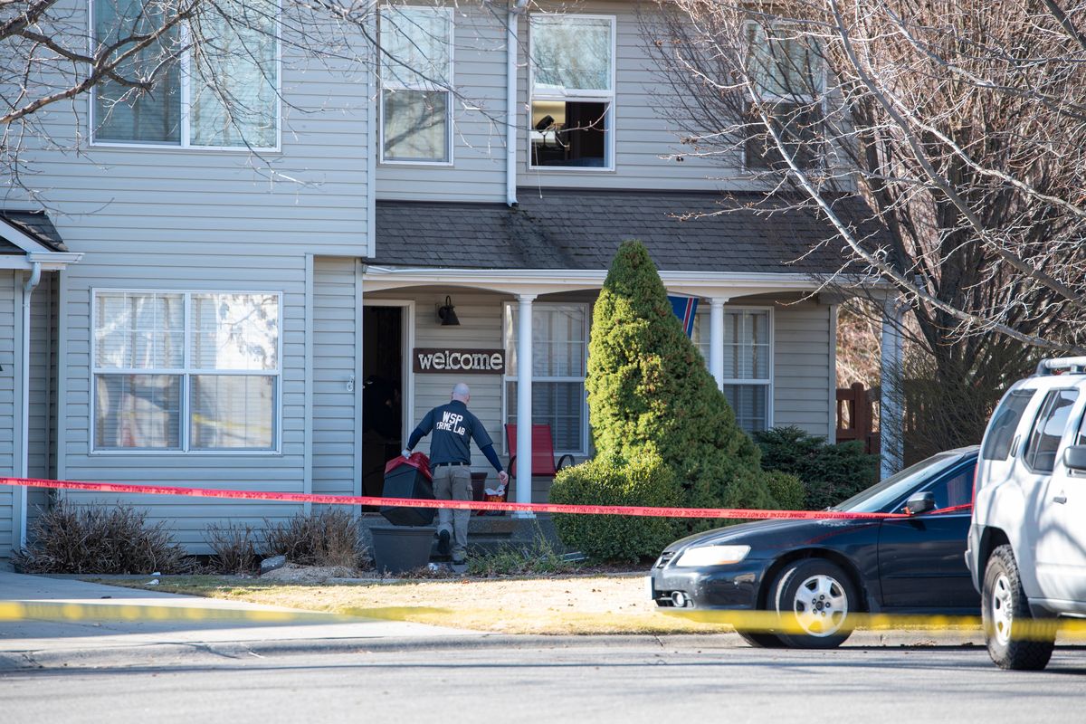 A crime scene investigator walks into a home Tuesday at 927 N. Malvern Circle in Liberty Lake as part of the investigation into a police-involved shooting overnight Monday.  (Jesse Tinsley/The Spokesman-Review)